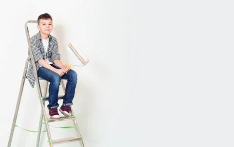 Boy with roller on ladder Stock Photos