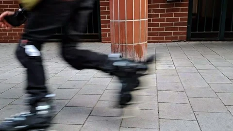 Boy rollerblading around pillar, urban environment Stock Footage 309517064