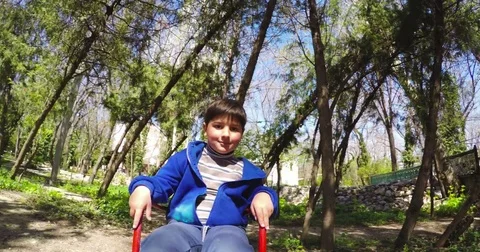 The boy is rolling from the children's hill Stock Footage 75560461