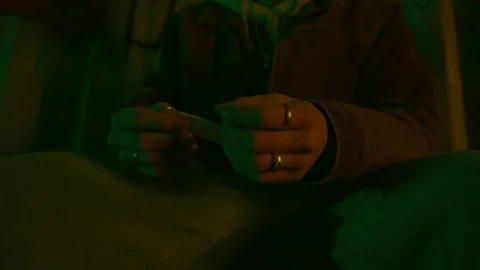 A boy rolling a cigarette close up Stock Footage 234389084