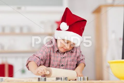 Boy rolling dough on kitchen counter Stock Photos