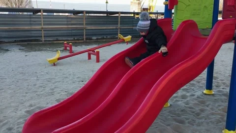 The boy rolling down the hill on the Playground. Stock Footage 164928384