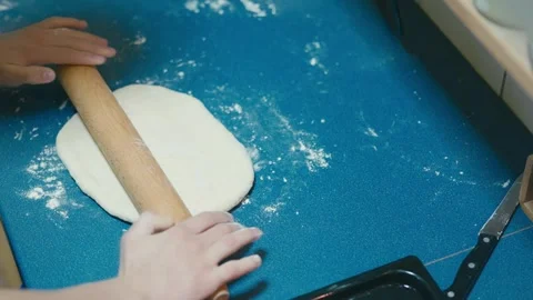 Boy is rolling pizza dough Stock Footage 255886323