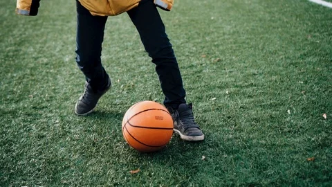 The boy rolls the ball around the field trying to beat the opponent Stock Footage 125856729