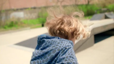 The boy rolls down the hill on the playground Stock-Footage 76000087