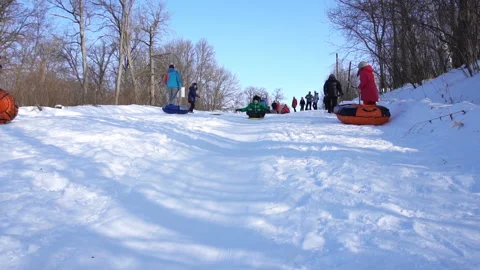 The boy rolls down the mountain in the snow Video stock 85927303