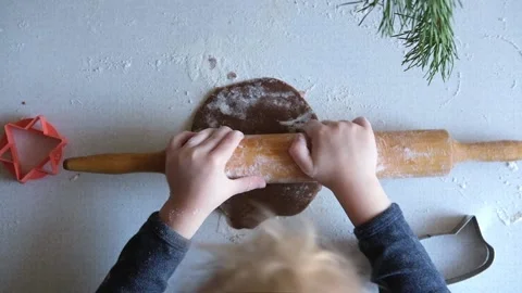 Boy rolls out cookie with rolling pin. Toddler makes gingerbread for Christmas. Stock Footage 165873002