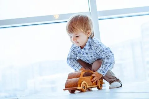 Boy rolls a toy car Stock Photos