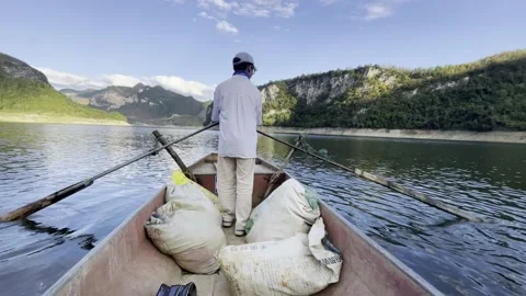 The boy rowed the boat and was ready to go fishing Video stock 232118348