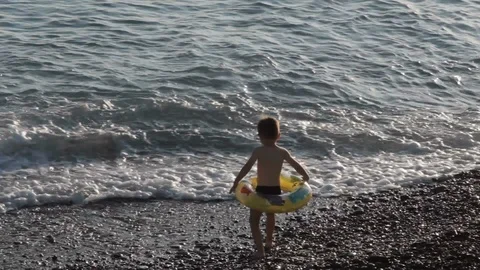 The boy with the rubber ring goes under the sea Stock Footage 108682600