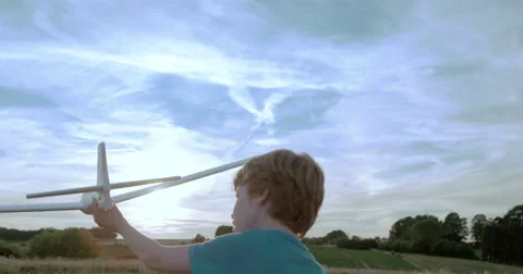 Boy running and playing with toy airplane at sunset Stock-Footage 53276356
