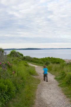 Boy Running Away on Oceanside Path Stock Photos