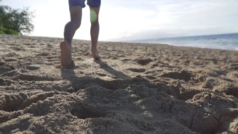 Boy running barefoot down beach in slow motion (UNGRADED) Stock Footage 78155488