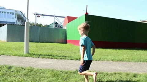 Boy running barefoot on the grass Stock Footage 52823209