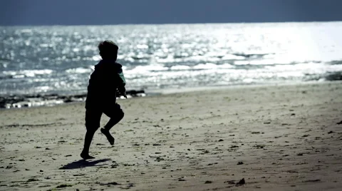 Boy running on the beach Stockbeeldmateriaal 58731573