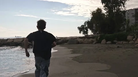 Boy is running on a beach Stock Footage 228864955
