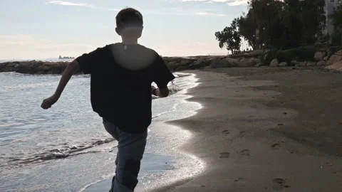 Boy is running on a beach Stock Footage 228864963
