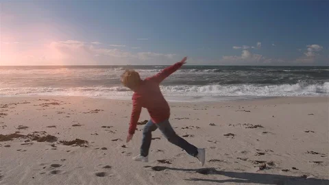 Boy running on the beach in the middle of autumn. Stock Footage 100559225