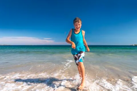 Boy running at the beach Stock Photos