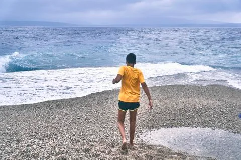 Boy running on the beach Stock Photos