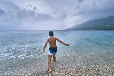 Boy running on the beach Stock Photos