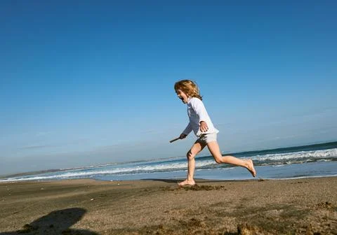 Boy running at the Beach Stock Photos