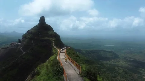 A boy running on the bridge top of the mountains, Boy with open handed running Stock Footage 285925729