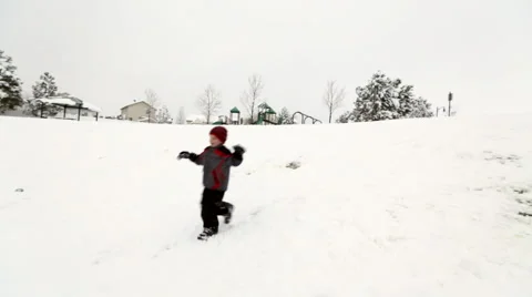 Boy running down snow hill Stock Footage 45021250
