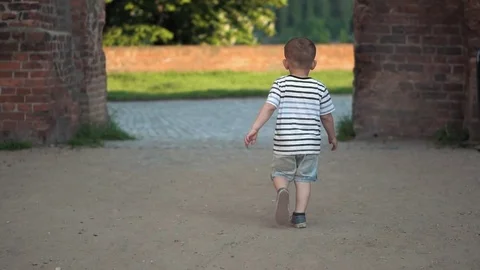 Boy running on a dry play field with dust  Stock Footage 79927038