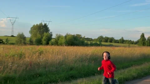 The boy running in the evening. 4k video in slow motion Stock Footage 203419888