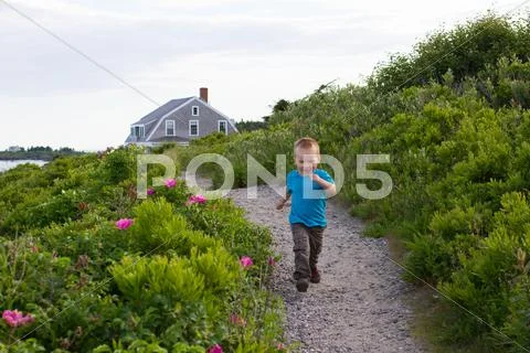 Boy Running With Home In Background