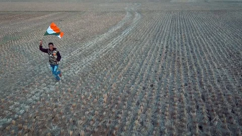 Boy running with Indian Flag drone shot Stock Footage 110895333