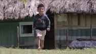 Boy Running Outside A Hut In Village, Guatemala Stock Footage