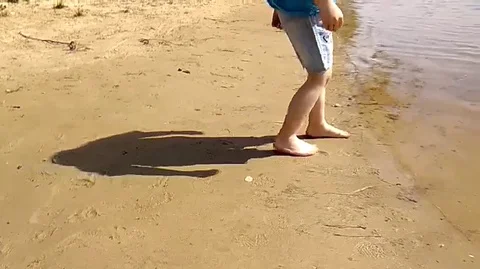 The boy is running on the river Video stock 80446616