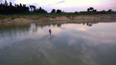 A boy running in a river water Stock Footage 94125802