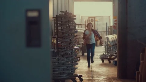 Boy running running in the warehouse. shot in slow motion Stock Footage 75783556
