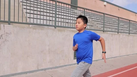 Boy Running On School Track Vídeo Stock 257625828