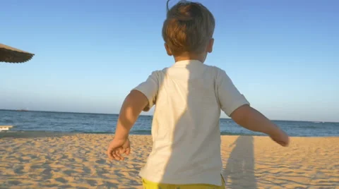 Boy Running to the Sea Stock Footage