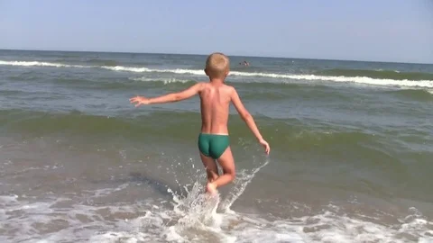 Boy running in the sea Stock Footage 74843940
