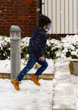 A boy running in the snow Stock Photos