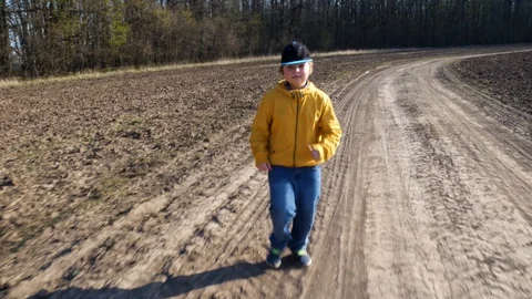 Boy running in a spring field Stock Footage 129190704