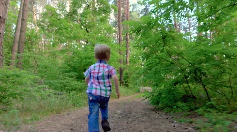 Boy running through the forest Stock Footage 64261261