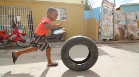 Boy Running Through Streets With Tire Dominican Republic Video stock 67134352