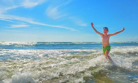Boy running through the water Stock Photos