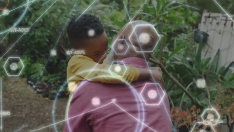 Boy running toward senior on yard path, jumping, seeking hug while tech hex HUD Stock Footage 333830522