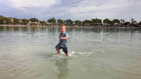 Boy running on the  water.Slow Motion Stock Footage 71351963