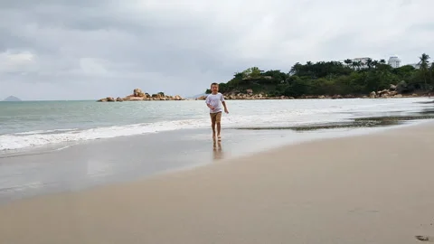 Boy running from wave to camera. Stock Footage 266385594