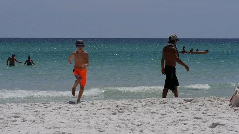 Boy running on white sandy beach Stock Footage 101616028
