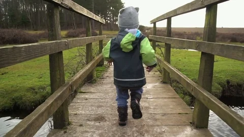 Boy running on the wooden bridge Stock Footage 84315186