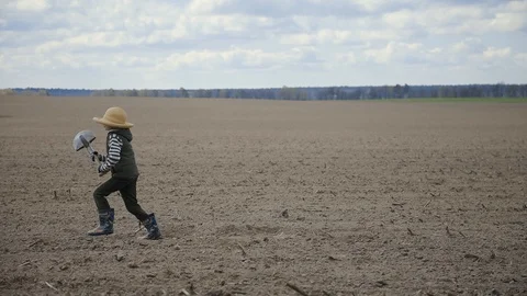 The boy runs across the field Stock Footage 128913129